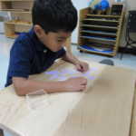 A child using small pieces of paper to study (150x150)