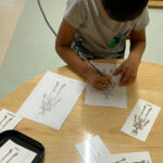 A little boy coloring the human skeleton drawings (150x150)