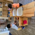 Two little boys learning how to wash dishes (150x150)