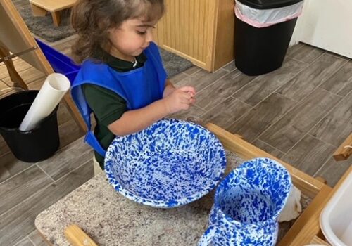 A blue basin in front of a child
